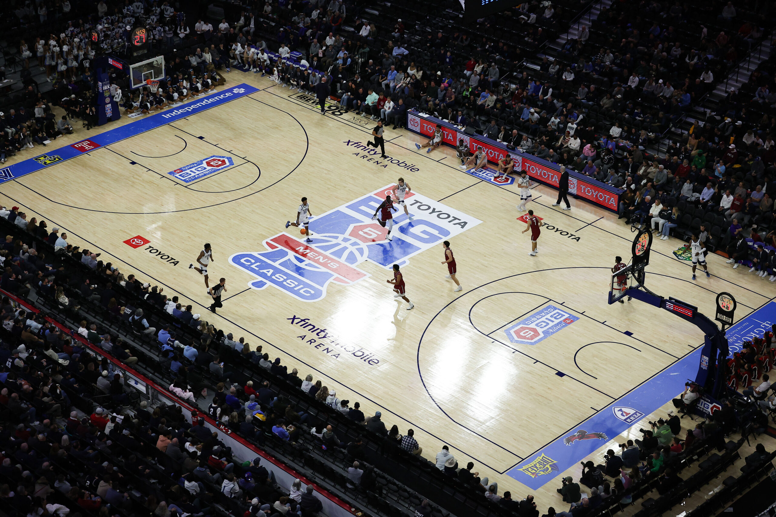 Aerial view of a game being played on a basketball court with the Big 5 logo at center court