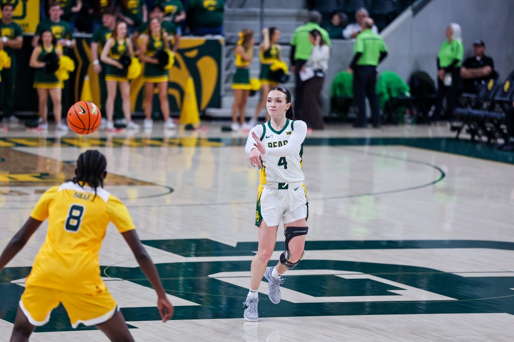 Baylor guard Jana Van Gytenbeek passes at the ball just beyond the half court line during a home game for Baylor.