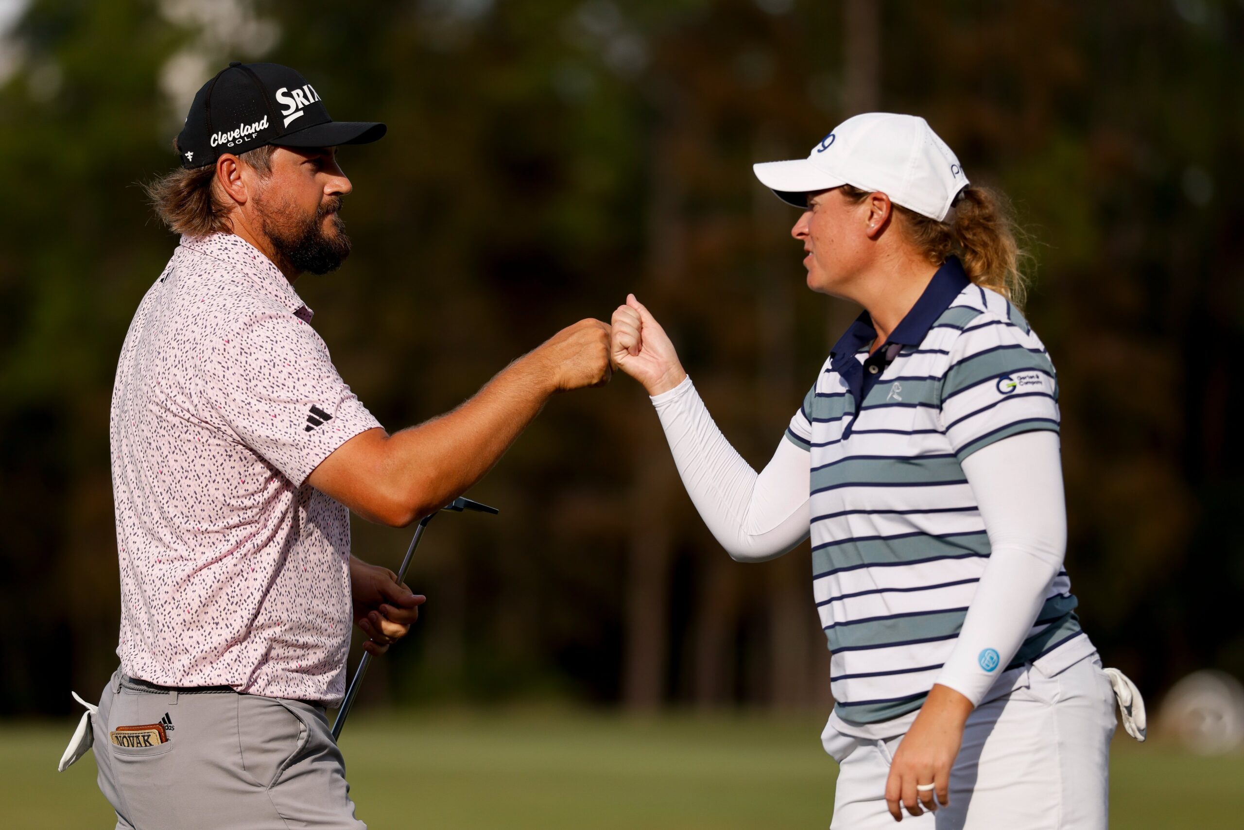 Andrew Novak and Lauren Coughlin, winners of the 2025 Grant Thornton Invitational, lean in and extend arms to fist bump after a birdie putt was made on the green at Tiburon Golf Club.