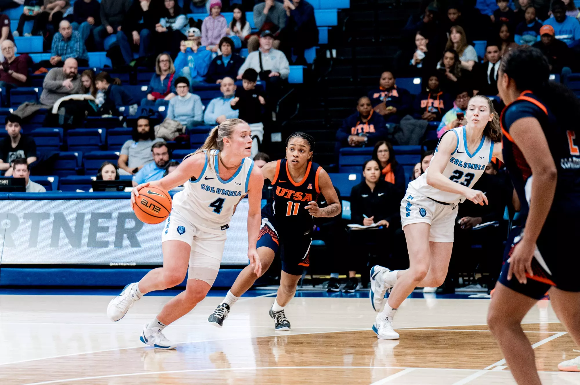 Columbia guard Fliss Henderson dribbles the ball with her right hand. She has just stepped inside the 3-point line, and she has room in front of her to attack or a teammate cutting down the lane to try to pass to.