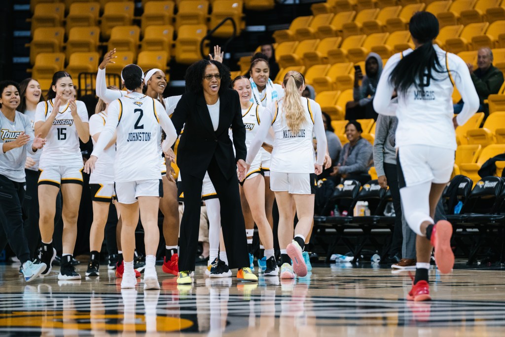 Towson celebrates a great play by running toward head coach <a rel=