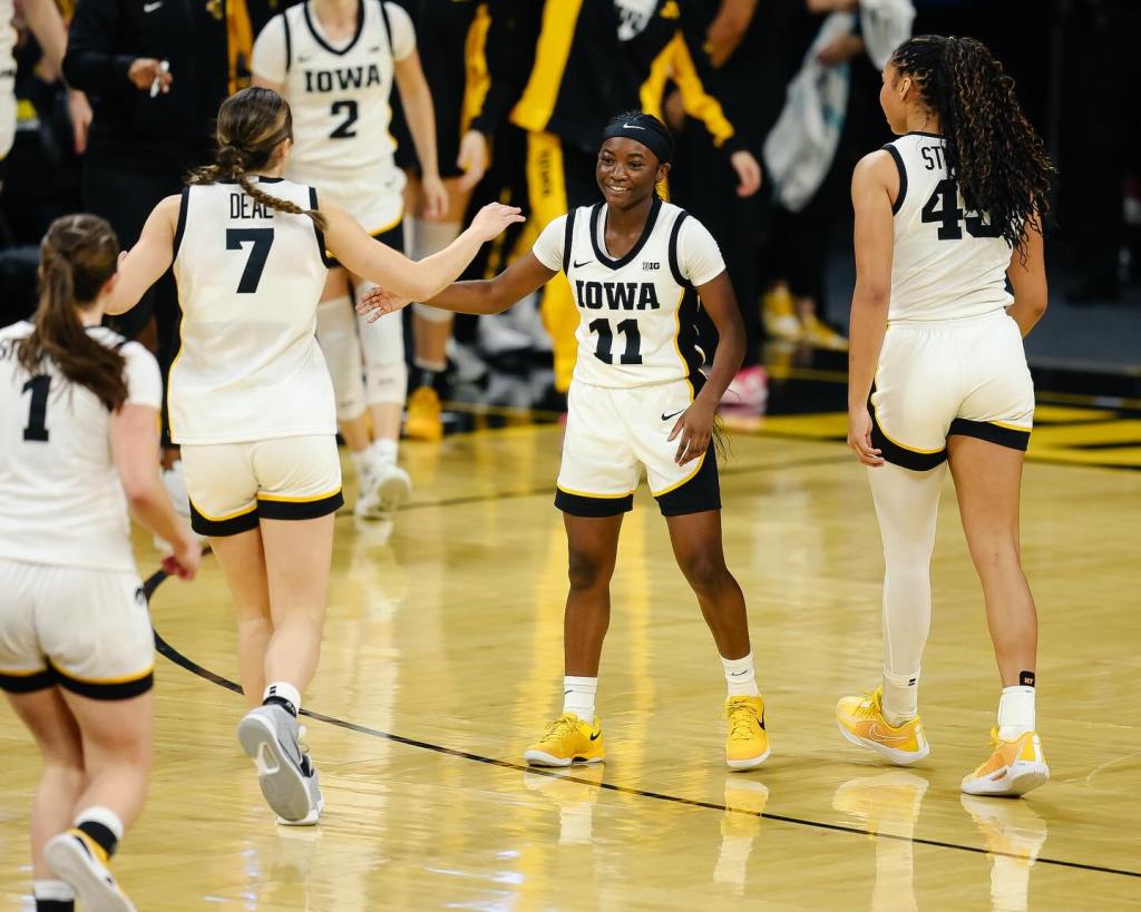 Iowa guard Chazadi “Chit-Chat” Wright (11) high-fives freshman guard Addie Deal (7) during a game at Carver-Hawkeye Arena in Iowa City, Iowa.