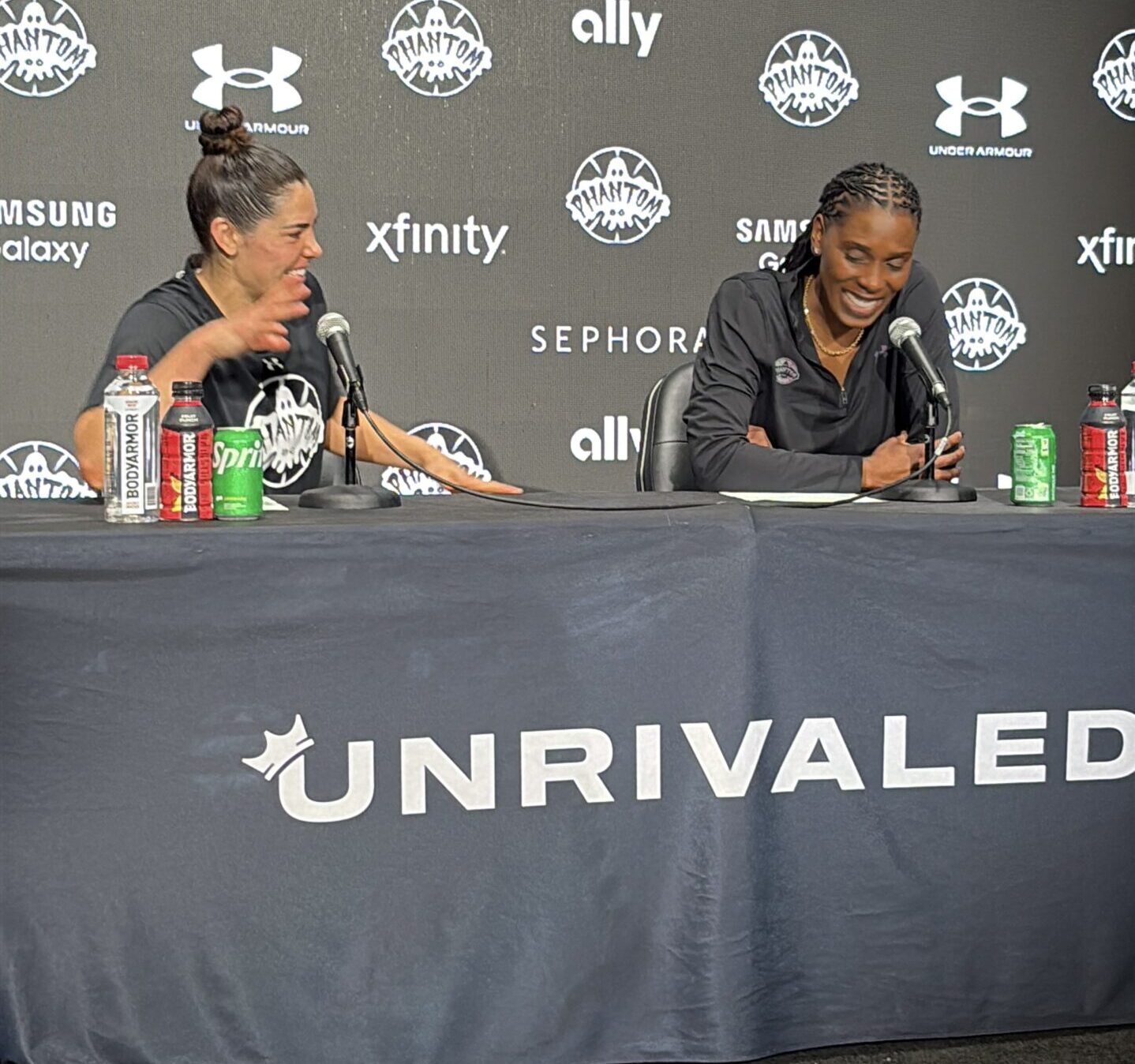 Kelsey Plum and Roneeka Hodges, laughing at the podium.