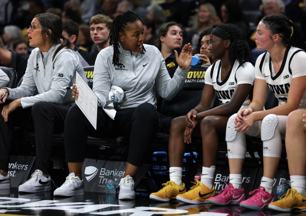 Iowa Hawkeyes assistant coach LaSondra Barrett talks to guard Chazadi 'Chit-Chat' Wright (11) on the bench during a game at Carver-Hawkeye Arena.