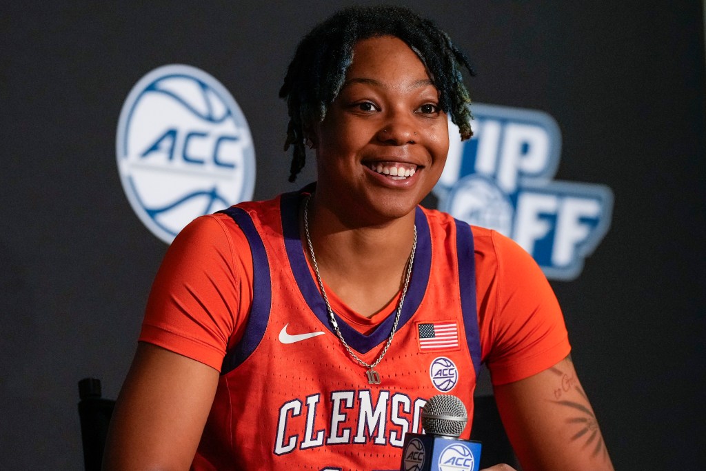 Gabby Elliott, wearing an orange Clemson Tigers jersey, speaks to the media at the ACC Tip Off event in Charlotte before her sophomore season in Oct. 2021.