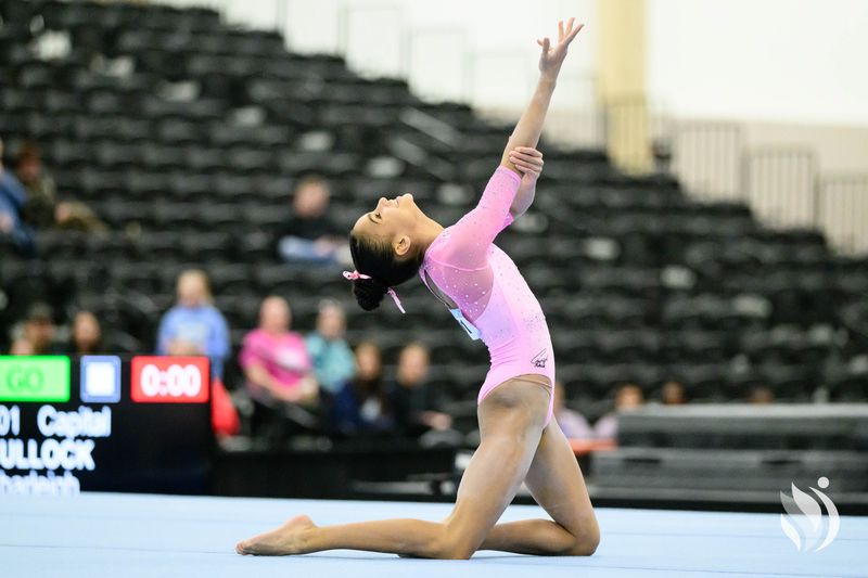 Hezly Rivera performs on floor in a pink leotard