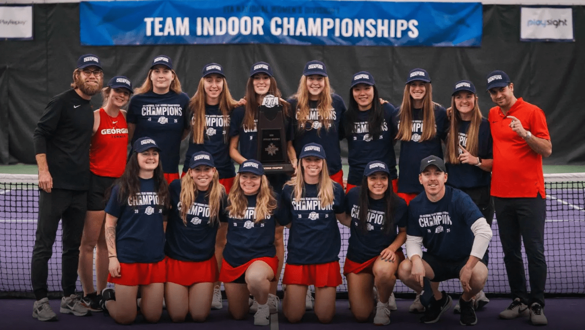 University of Georgia's women's tennis team poses with their ITA National Indoor trophies.