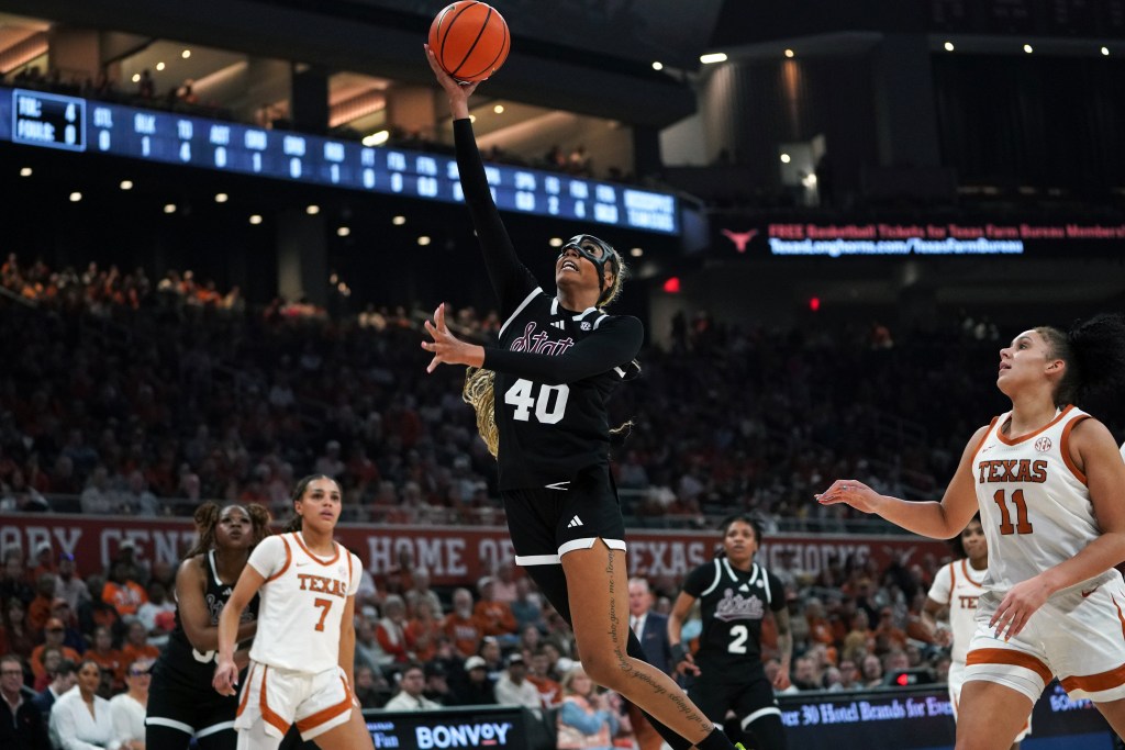 Madison Francis attempts a layup under the basket.