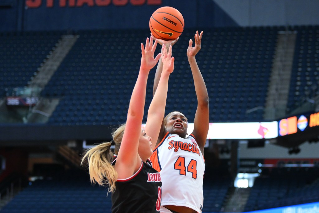 Uche Izoje pulls up for a jump shot over a defender.