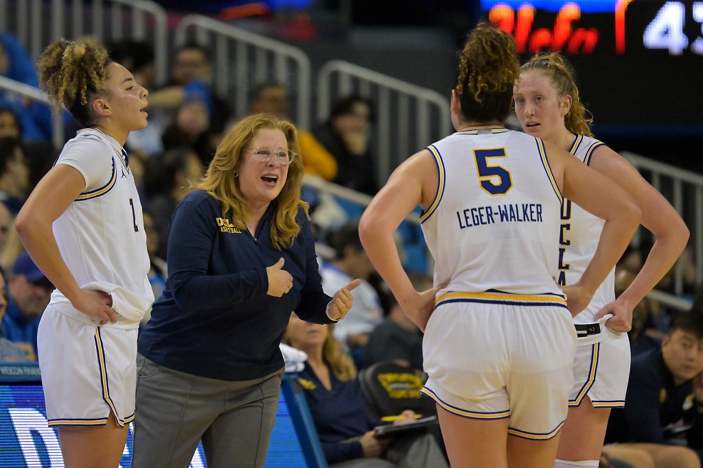 UCLA Bruins head coach Cori Close talks with guard Kiki Rice (1), guard Charlisse Leger-Walker (5) and  guard Gianna Kneepkens (8) in a huddle on the sideline.