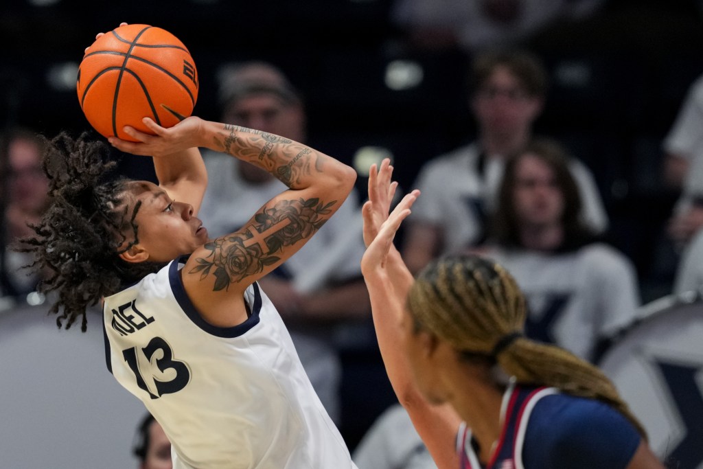 Mariyah Noel shoots a contested jump shot over the outstretched hand of a defender