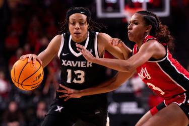 Xavier Musketeers guard Mariyah Noel (13) drives on Cincinnati Bearcats guard Reagan Jackson (3)