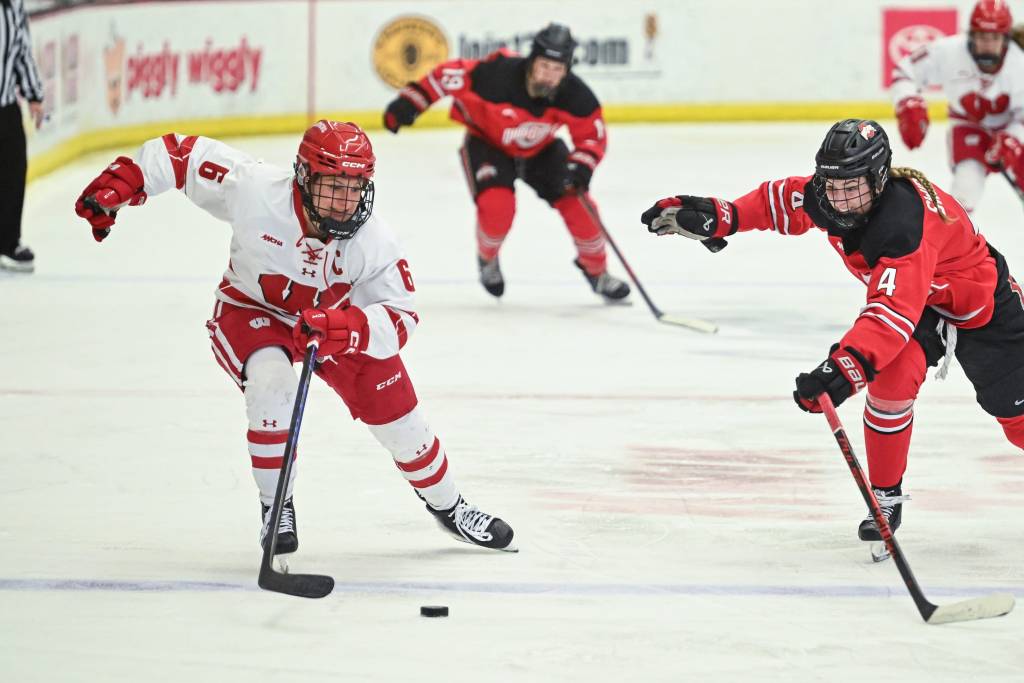 Wisconsin right wing Lacey Eden and Ohio State defender Sara Swinderski pursue the puck