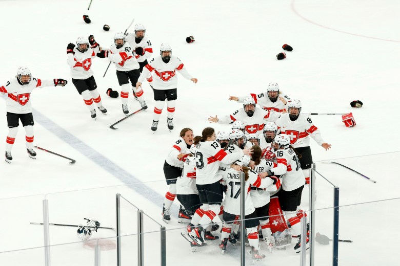 Switzerland celebrates around the blue line after tossing off their helmets and gloves.