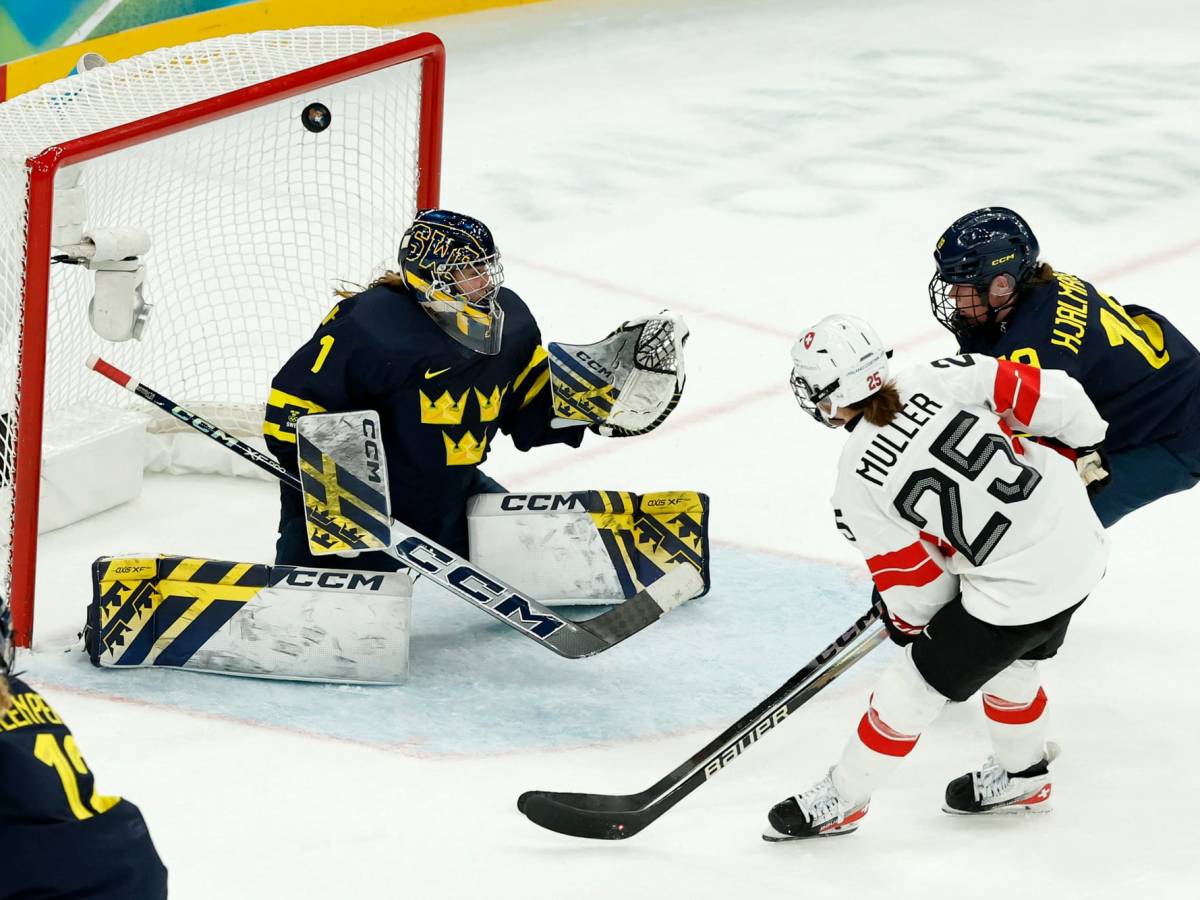 Alina Muller of Switzerland shoots the game-winning shot past the Sweden goalie.