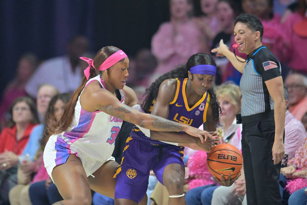LSU's Flau'jae Johnson and Mississippi forward Cotie McMahon battle for a loose ball.