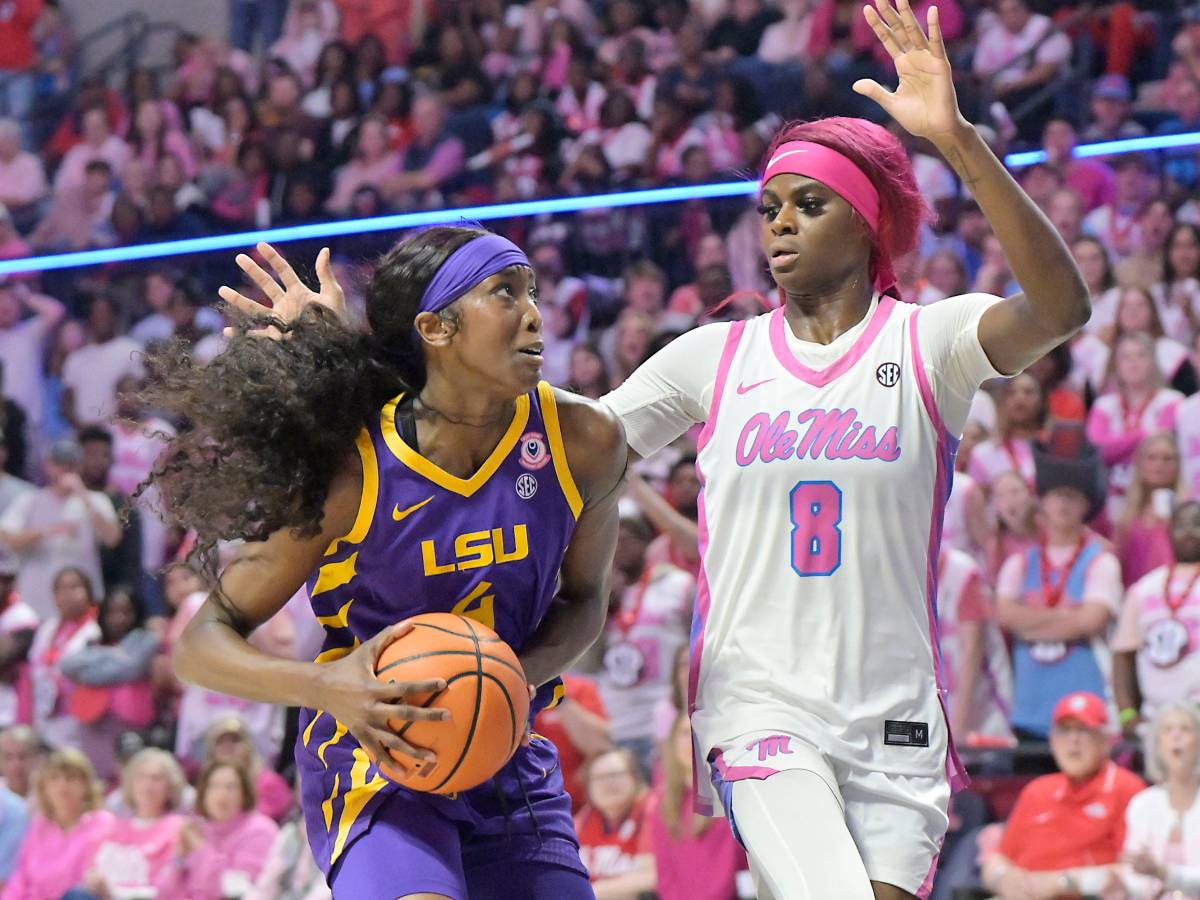 With a large crowd in the background, LSU's Flau'jae Johnson drives the the basket against Mississippi forward Latasha Lattimore.