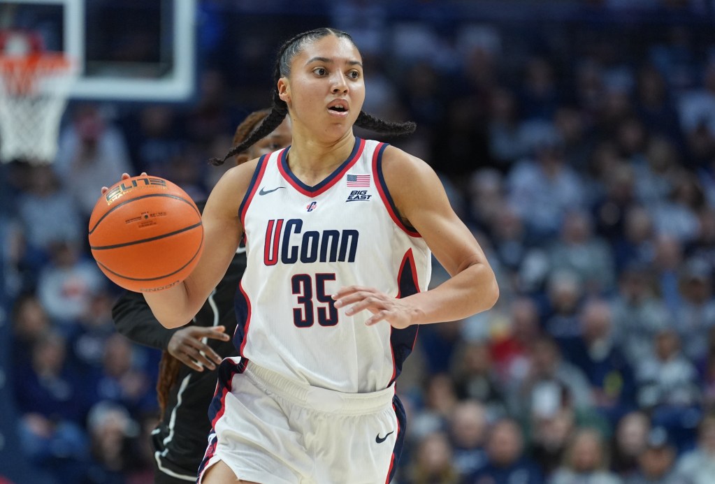 UConn guard Azzi Fudd dribbles the ball up the court with her right hand.