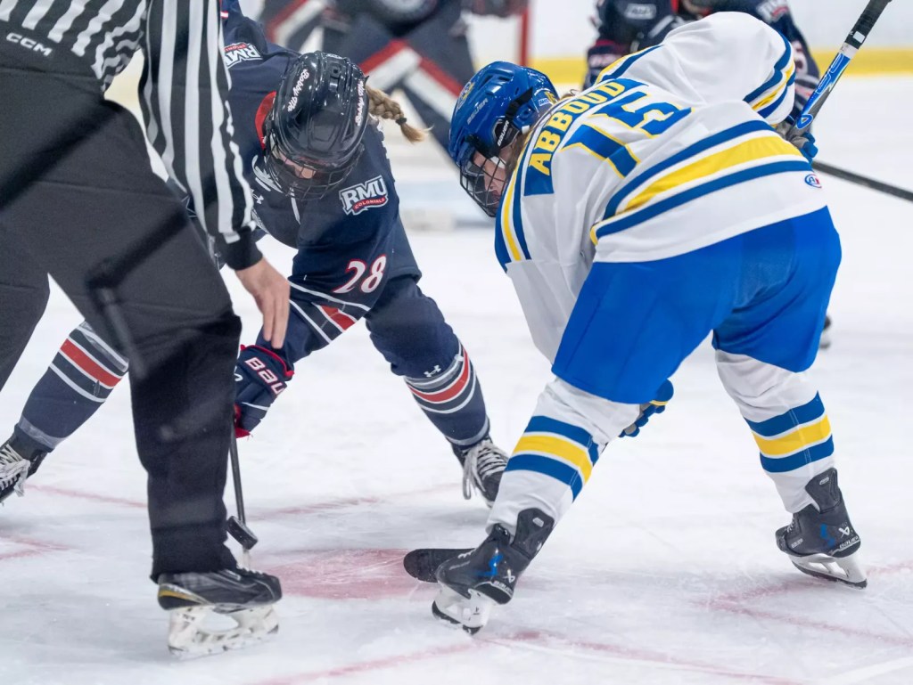 A player from Robert Morris and a player from Delaware face off.