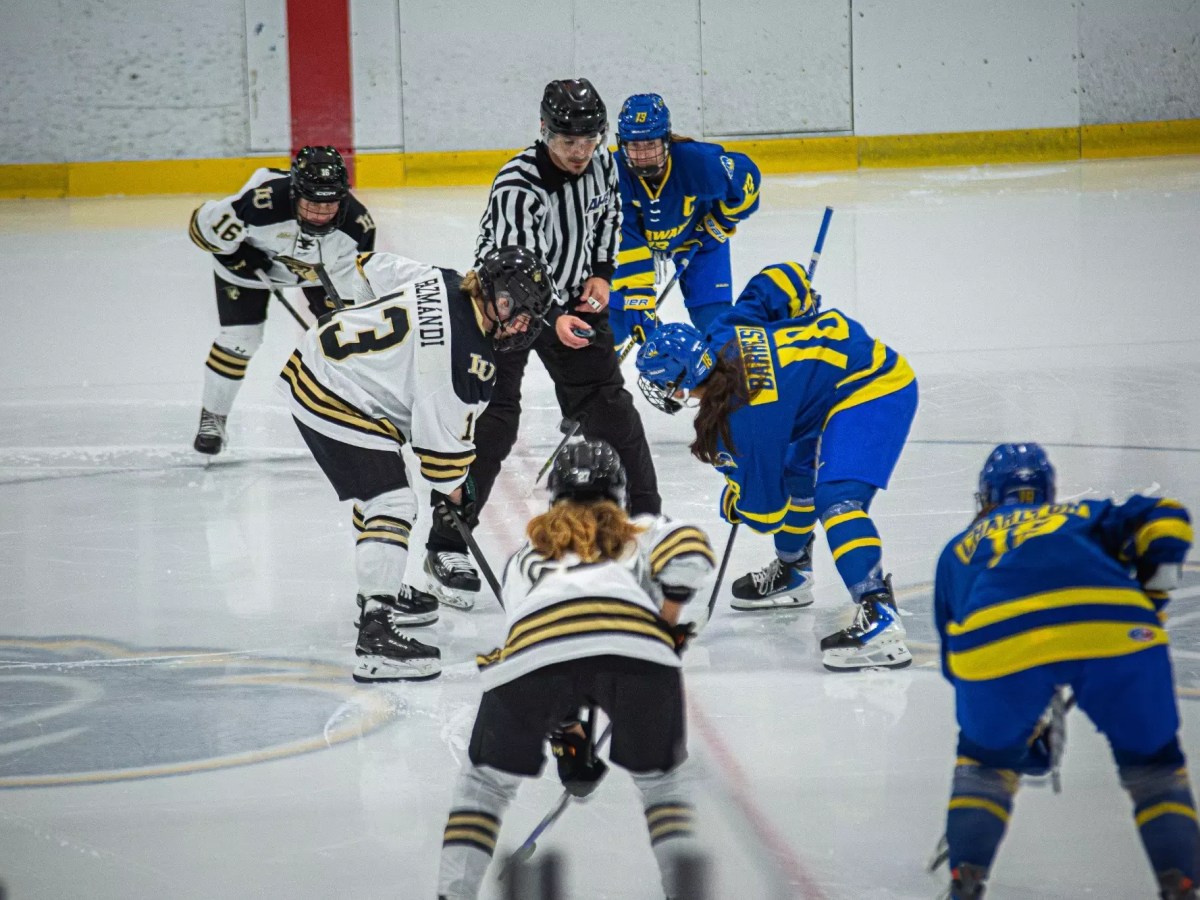 Delaware and Robert Morris players line up at center ice waiting for puck drop.