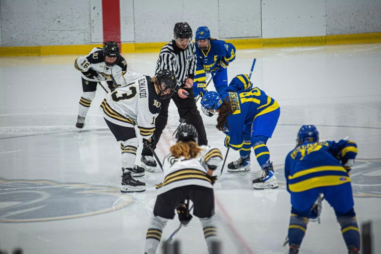 Delaware and Robert Morris players line up at center ice waiting for puck drop.