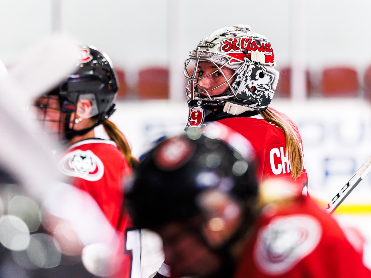 St. Cloud State goaltender Jojo Chobak looks on during a team huddle.