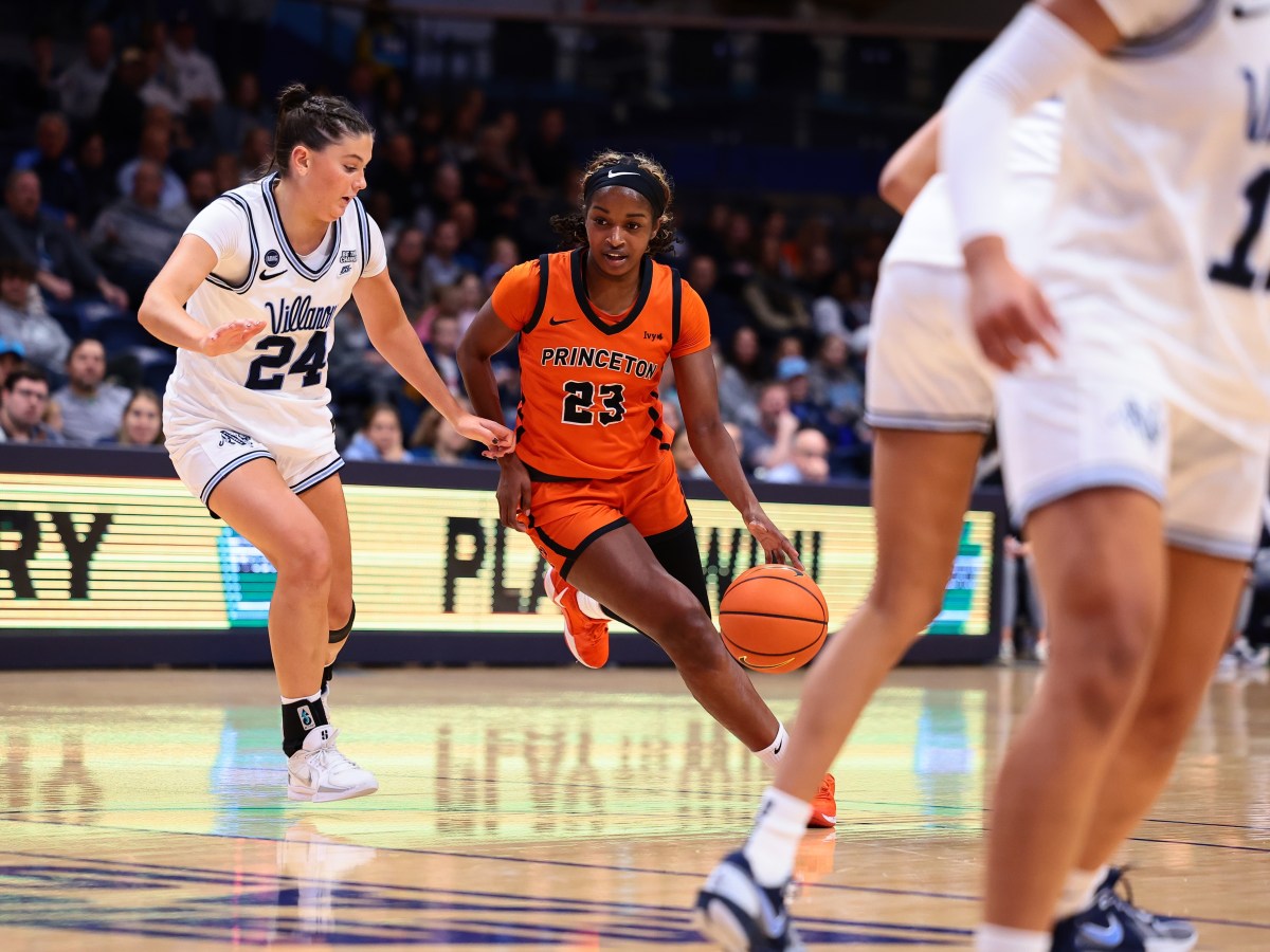 Princeton guard Madison St. Rose dribbles the ball with her left hand as a Villanova defender to her right tries to keep pace with her.