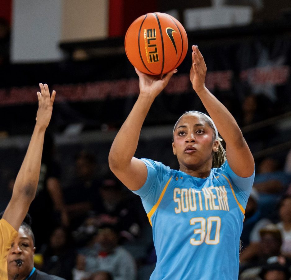 A player in a columbia blue uniform prepares to shoot the ball in a game.