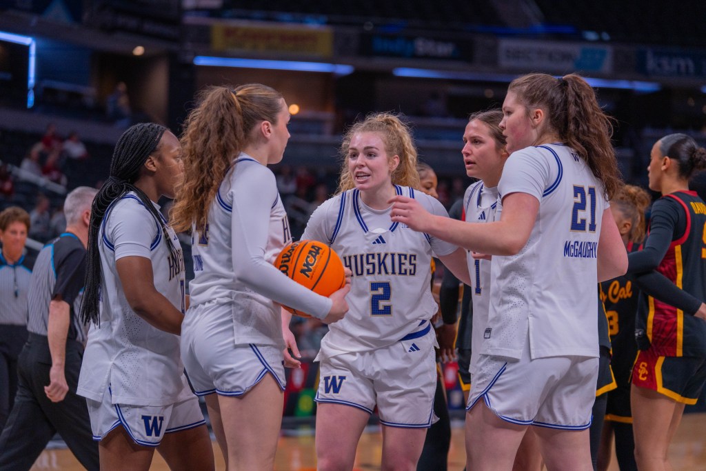 Washington guard Avery Howell gathers her team in a huddle, talking to them and using her arms to bring them around her, against USC in a Big Ten Tournament game on March 5, 2026, at Gainbridge Fieldhouse in Indianapolis, Ind.