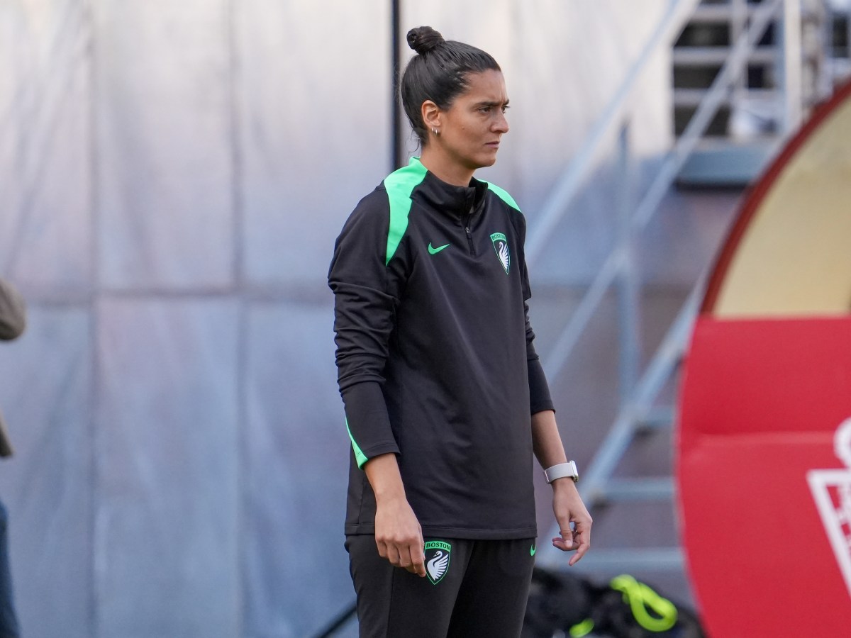 Boston Legacy FC head coach Filipa Patão stands and watches her team from the sideline.