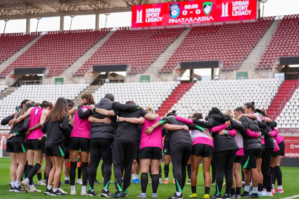 Boston Legacy players stand in a huddle on the pitch.