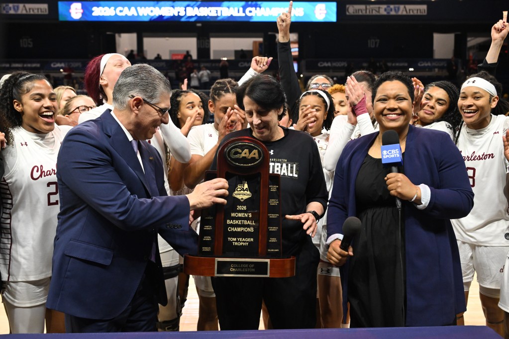 Charleston head coach Robin Harmony prepares to receive the trophy from Joe D'Antonio