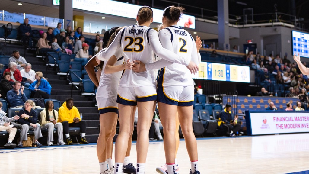 Mariah Watkins and Bria Watkins huddles with each other during a recent home game.