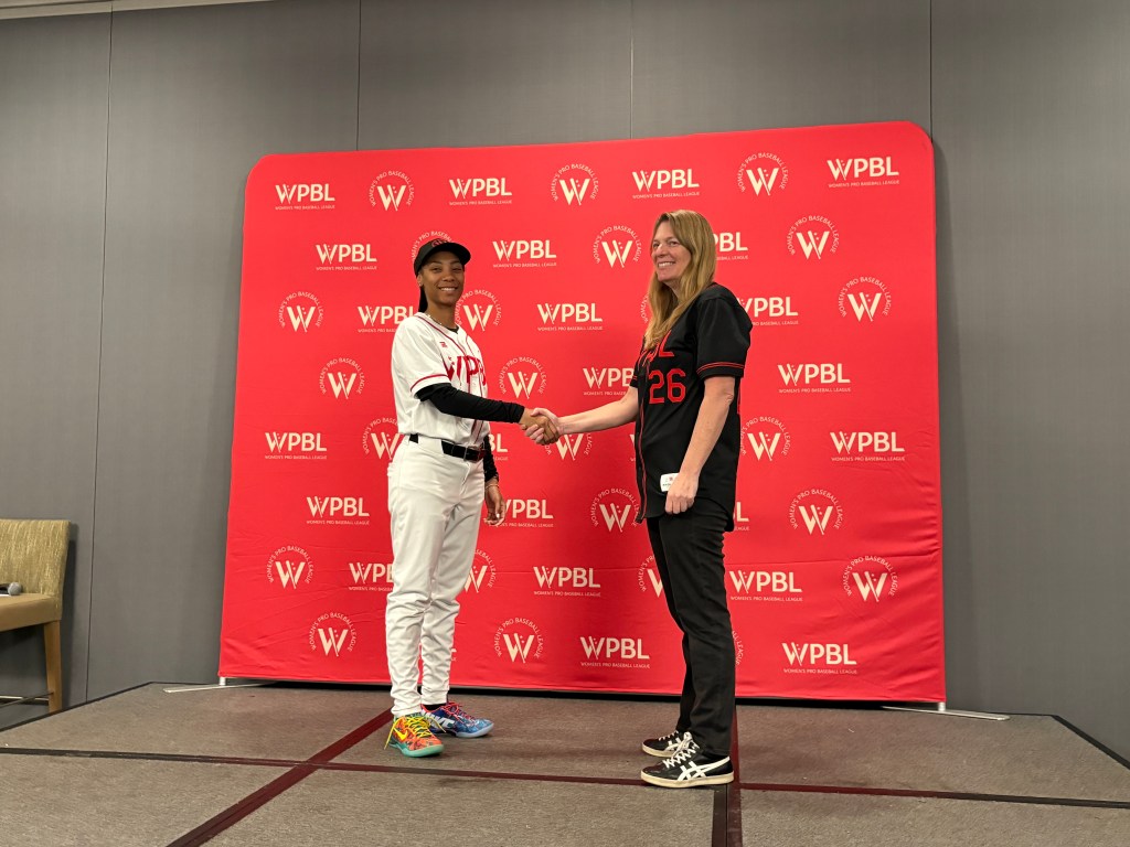 Mo'ne Davis and Justine Siegal shaking hands.
