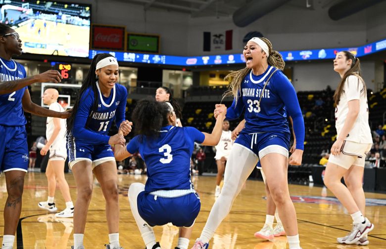 Indiana State guard Tierney Kelsey and forward Amerie Flowers celebrate with a yell as they help up teammate Jayci Allen during the Sycamores' 81-69 win over Southern Illinois in the first round of the 2026 Missouri Valley Women's Basketball Tournament.
