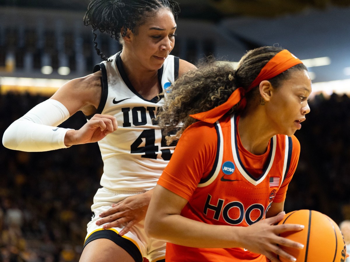 Iowa forward Hannah Stuelke defends Virginia guard Paris Clark under the basket during the second round at Carver-Hawkeye Arena in Iowa City, Iowa.