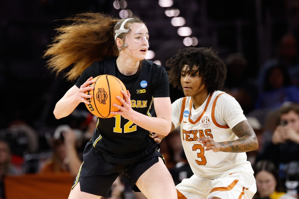 Michigan guard Syla Swords tries to go around Texas' Rori Harmon during the Elite 8 game of the 2026 NCAA Tournament.