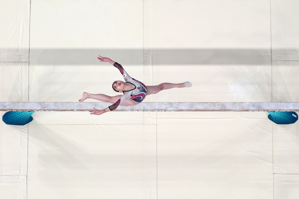 Mana Okamura of Japan performs on the beam. Photo is a view from above.