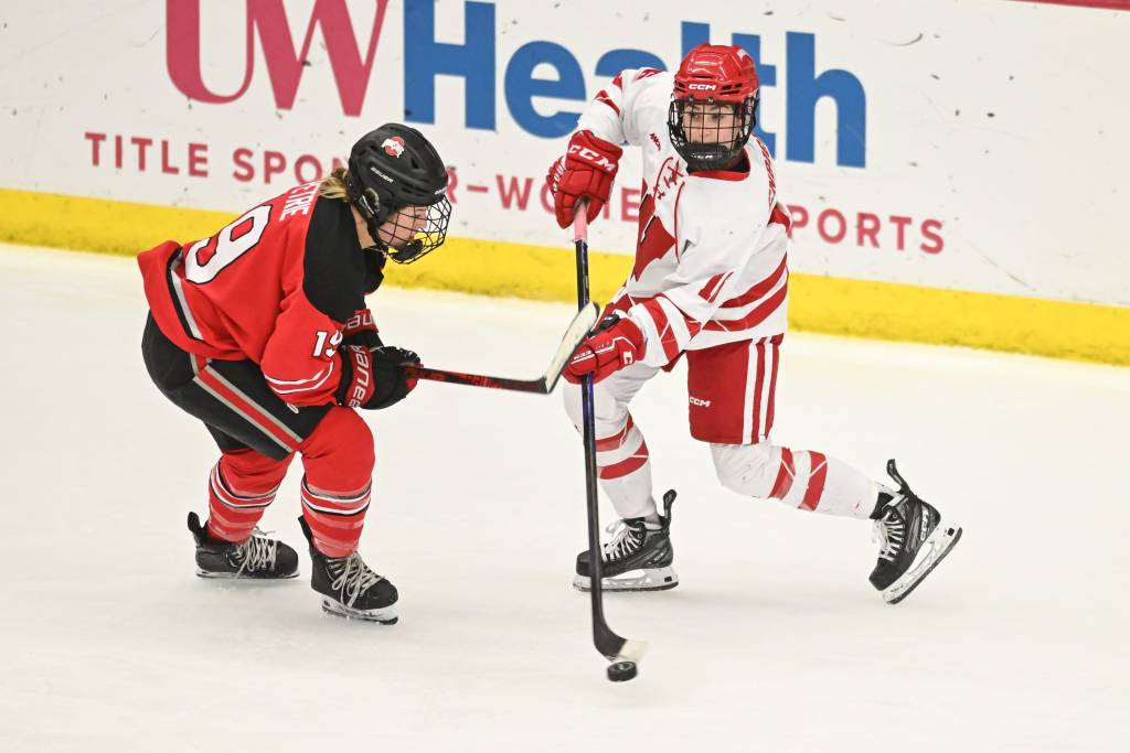 A Wisconsin player controls the puck with an Ohio State player defending.