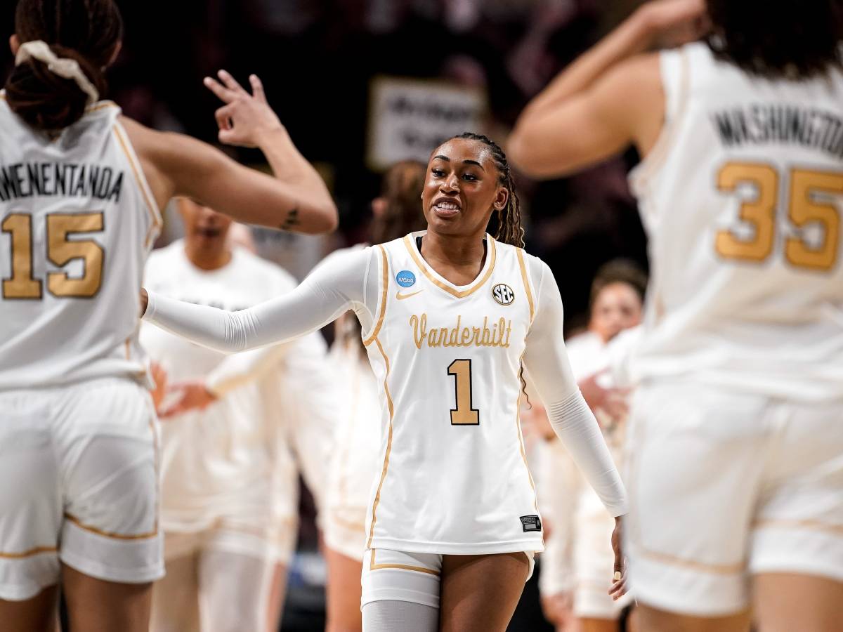 Mikayla Blakes high-fives teammates in front of the Vanderbilt bench.