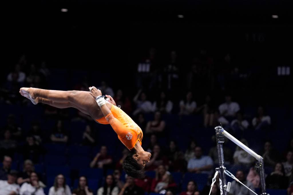 Selena Harris-Miranda is in mid-air during bars routine