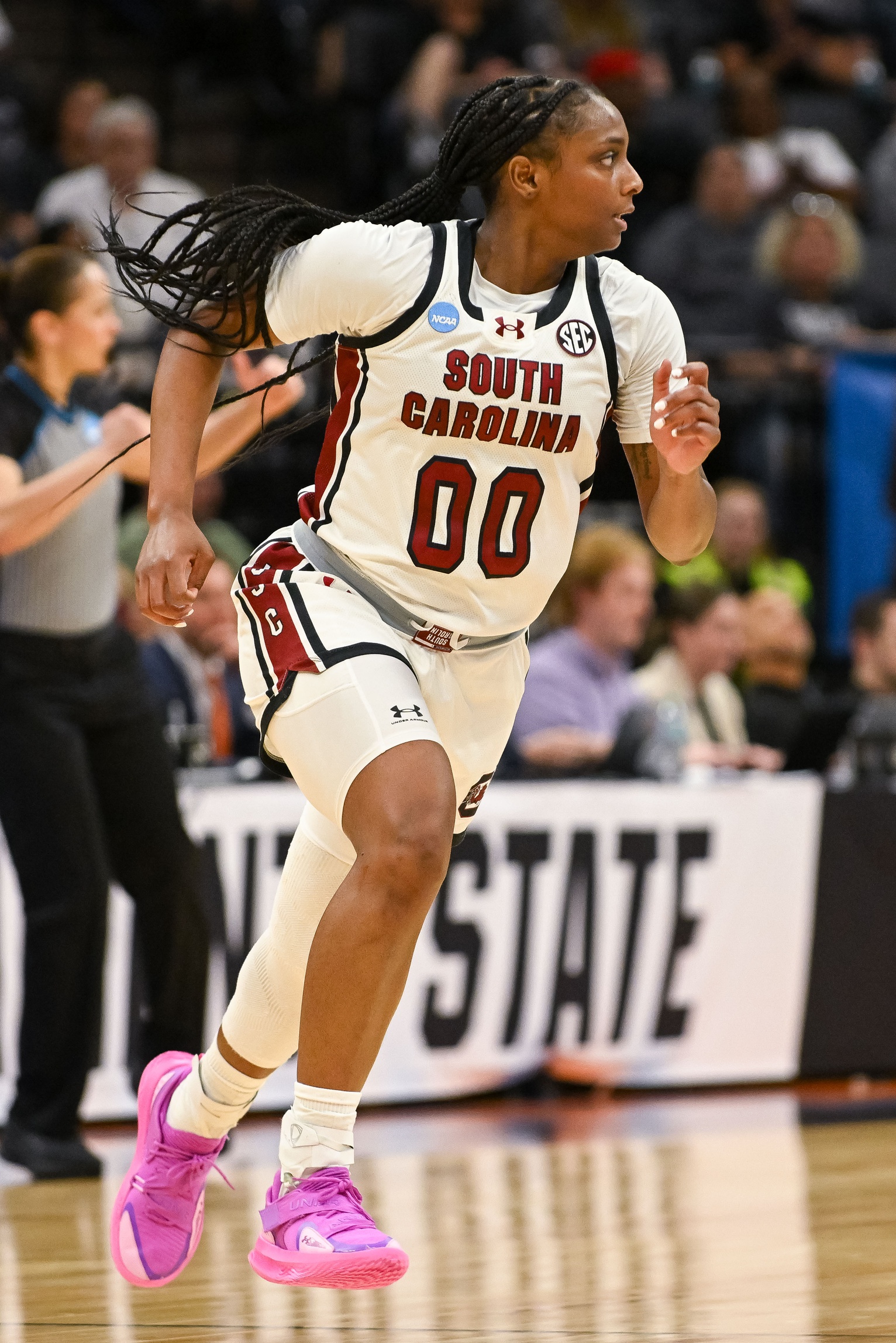 South Carolina guard Ta'Niya Latson runs the floor. She is alone with an out of focus  refree behind her.