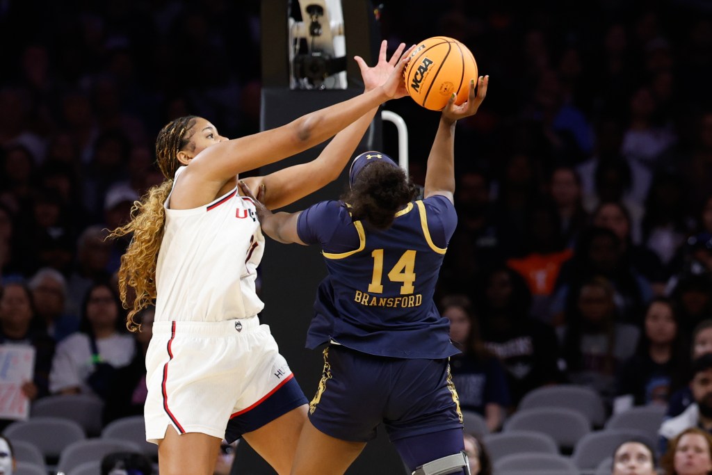 Sarah Strong two-hand blocks a shot attempt from KK Bransford