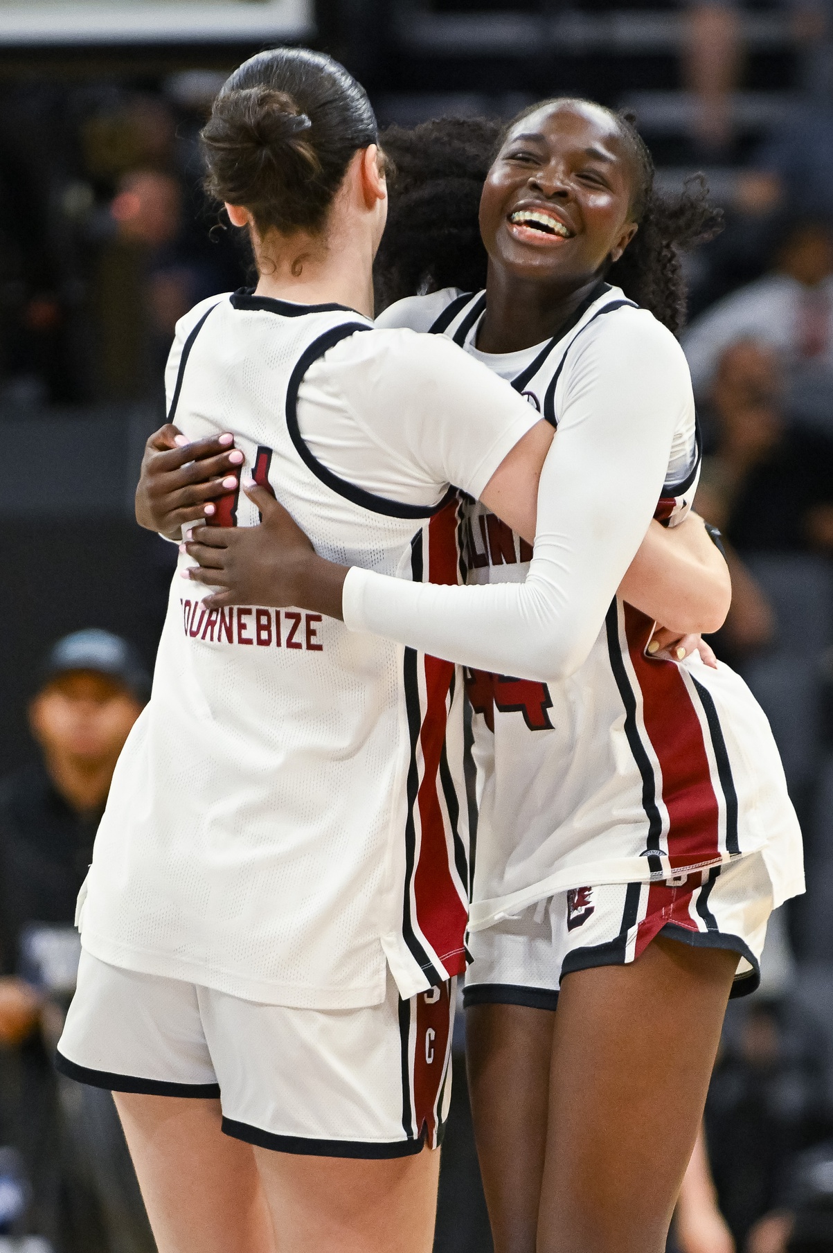 South Carolina Freshman Agot Makeer and Alicia Tournebize celebrate after beating TCU. They are hugging with Agot facing the camera and Alicia facing away.