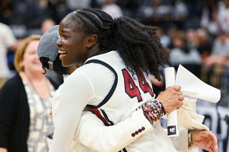 South Carolina guard Agot Makeer and head Coach Dawn Staley hug after clinching a spot in the Final Four. Dawn is being mostly covered by Agot.