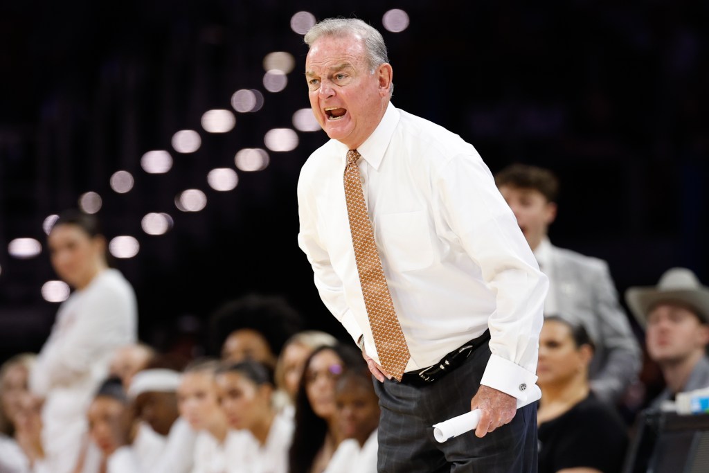 Texas head coach Vic Schaefer yells instructions to his team during the 2026 NCAA Tournament game of the Elite 8 against Michigan.
