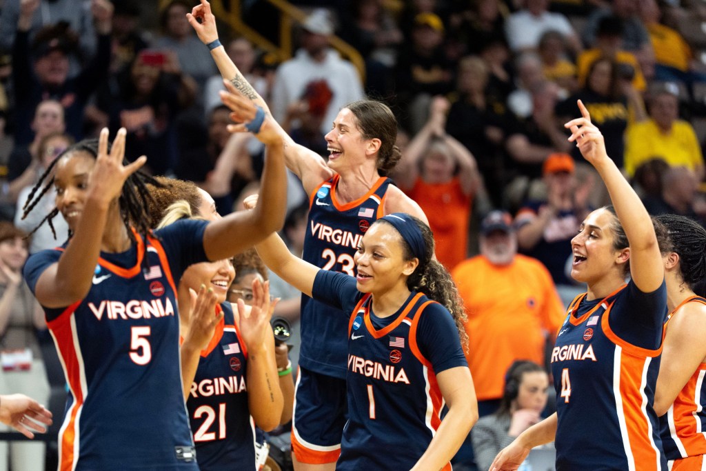 The Virginia Cavaliers raise their hands and give the number one sign after upsetting the Georgia Bulldogs during a First Round 2026 NCAA Tournament game at Carver-Hawkeye Arena in Iowa City, Iowa.