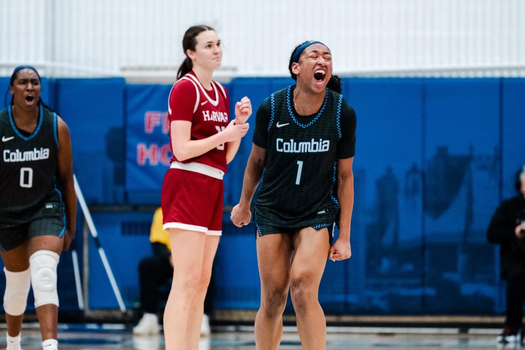 Columbia seniors Perri Page and Susie Rafiu clench their fists and yell in celebration.
