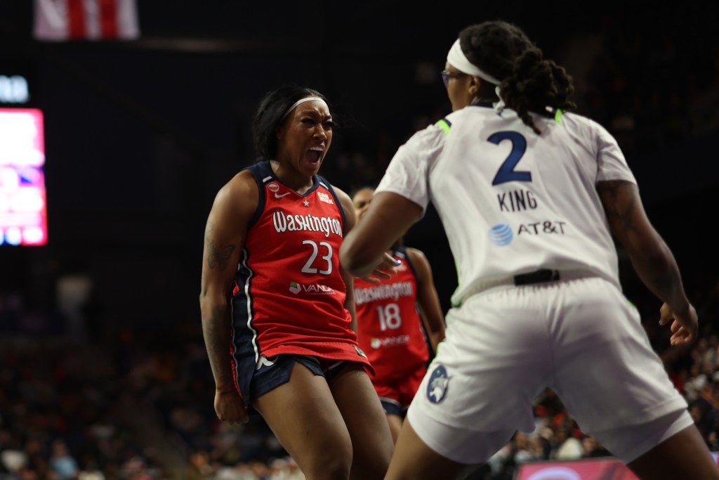 Washington Mystics guard/forward Cotie McMahon clenches her fists and yells after scoring a basket.