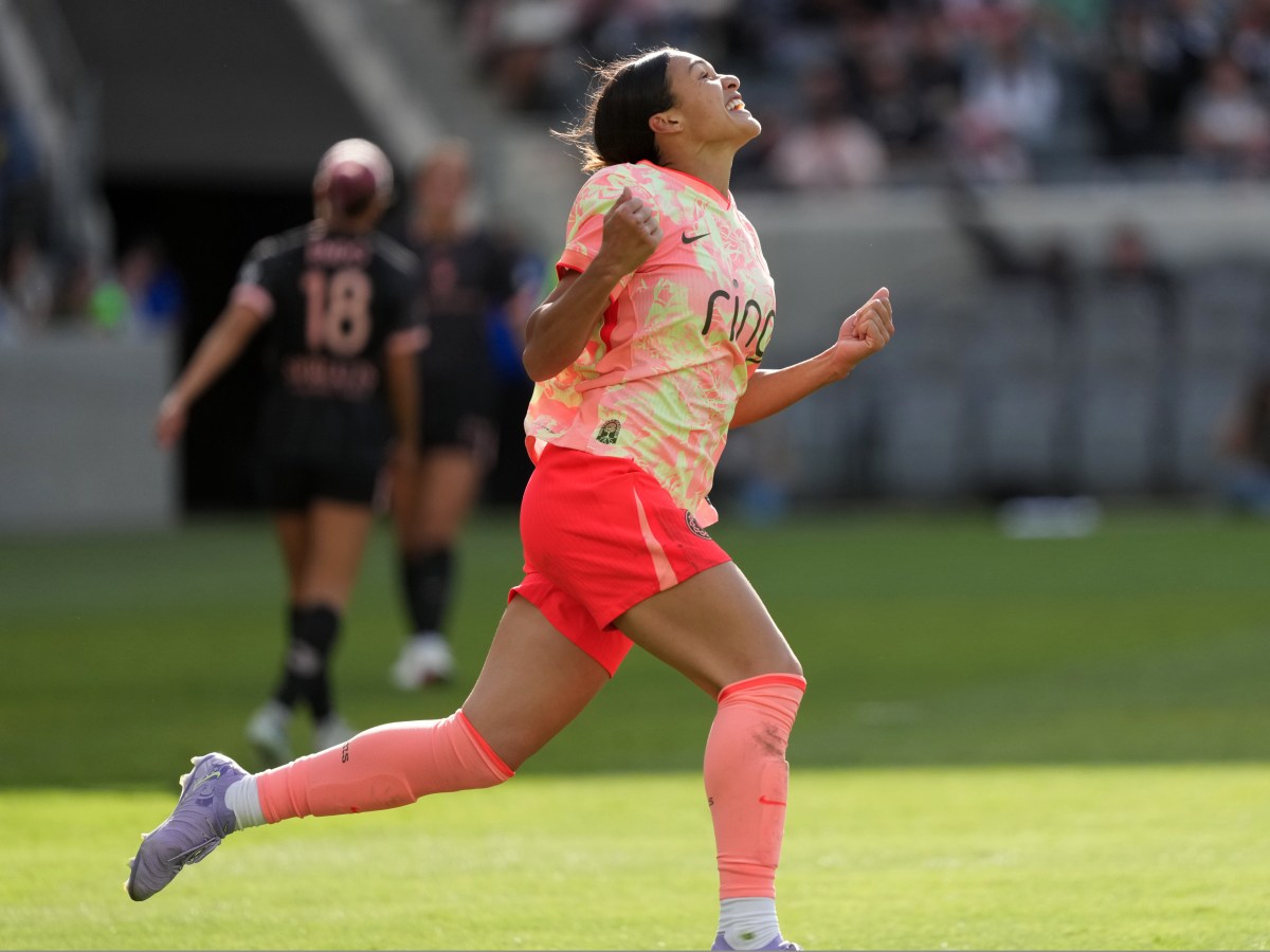 Sophia Wilson celebrates on the field after scoring a goal